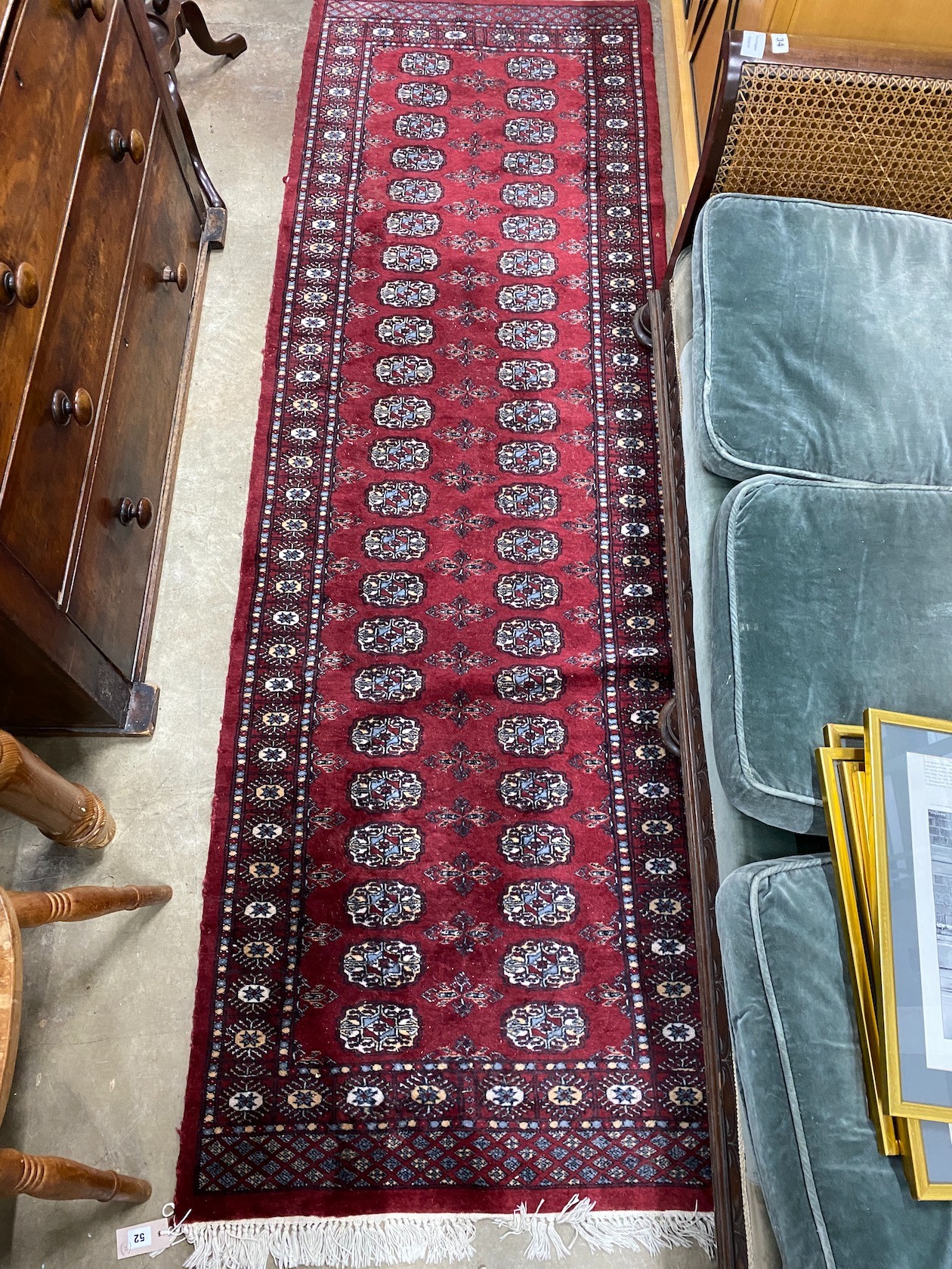 A Bokhara red ground runner and an Afghan rug, larger 250cms x 80cms.